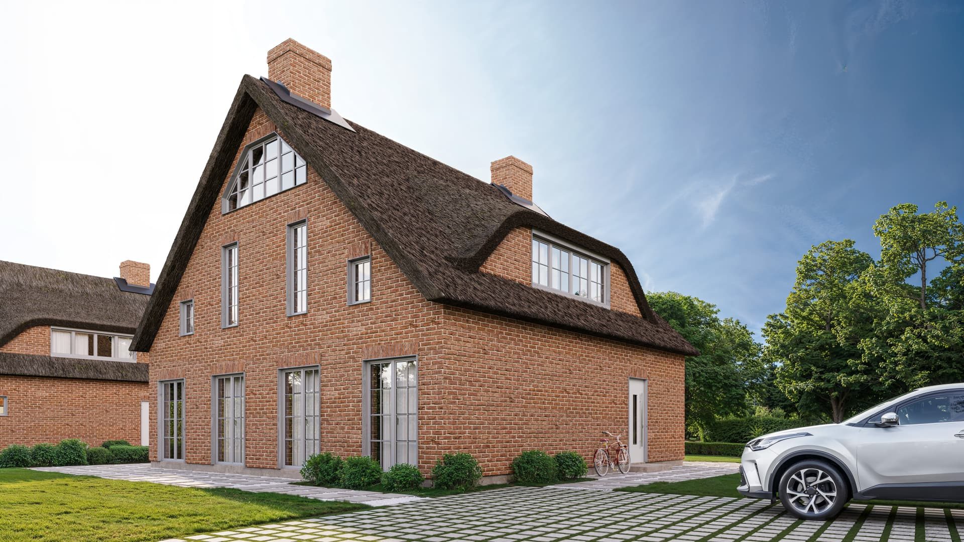 Haus 1 mit Reetdach, Fledermausgaube und Klinkerfassade